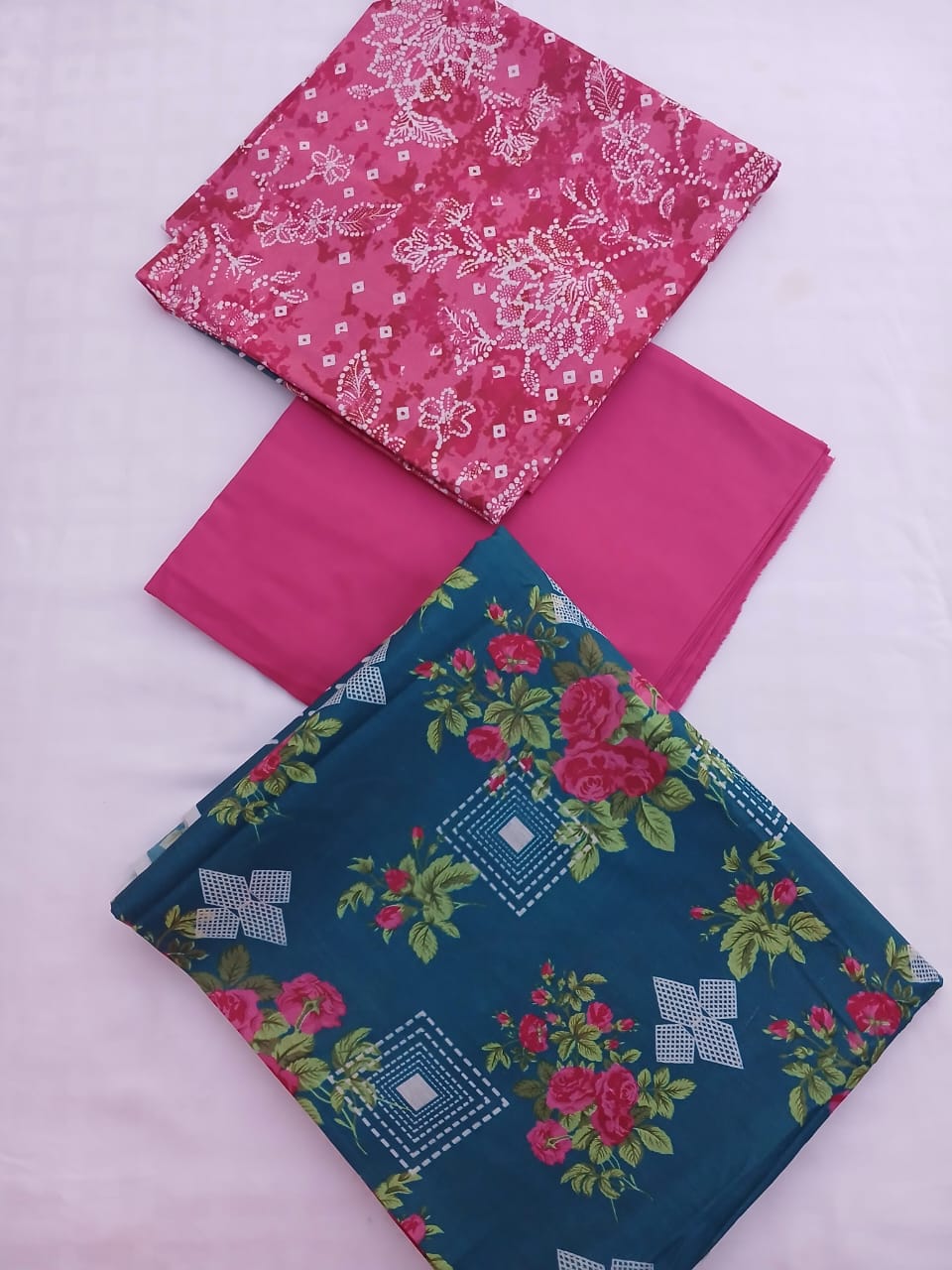 Beautifully packaged 3-piece unstitched lawn suit showing fabric borders and design details.