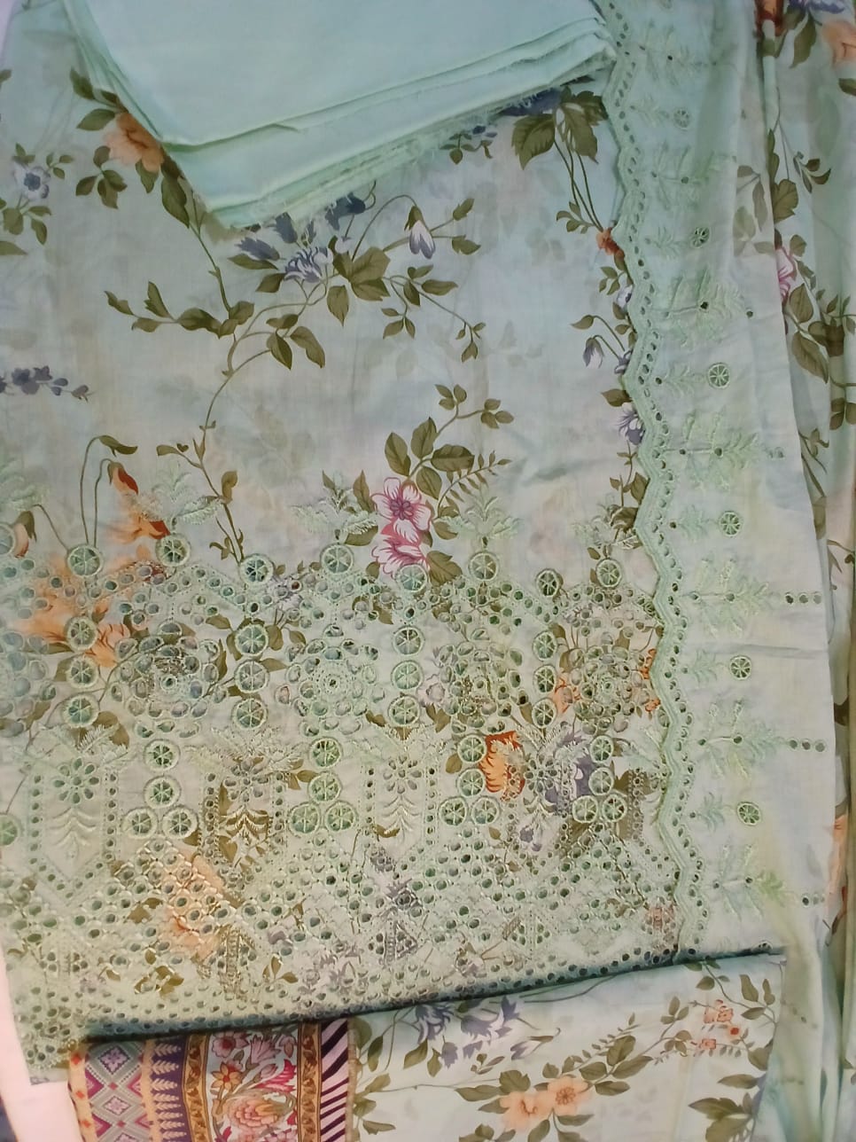 Complete three piece pastel green embroidered lawn suit with digital printed dupatta and cambric trousers