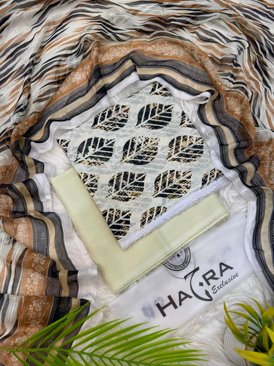 Aladeen Fabrics Hajra Exclusive off white printed lawn suit with golden brown and black floral design and chiffon dupatta